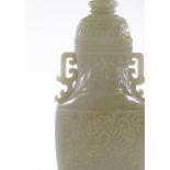 A large Chinese relief carved jade 2-handled vase and cover, on dark green jade pedestal, overall