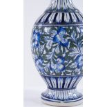 A Middle Eastern porcelain narrow-necked vase, with hand painted Iznik floral decoration, height