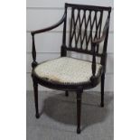 An Edwardian mahogany Hepplewhite style elbow chair, with lattice back