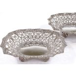 A pair of late Victorian oval silver bonbon baskets, with cast and pierced floral surround, by