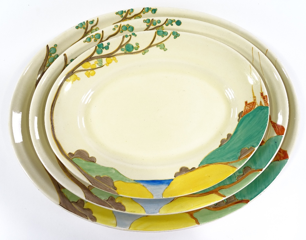 A graduated set of 3 Clarice Cliff Bizarre Red Roof pattern meat plates, largest length 42cm