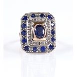 An 14ct gold sapphire and diamond cluster poison ring, with hidden central hinged poison