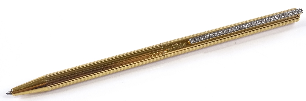 A Dupont gold plated Ballpoint pen with diamond set clip, total diamond content approx 0.5ct