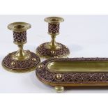 A French bronze desk stand with filigree border, and a pair of matching candlesticks