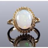 A 9ct gold cabochon opal dress ring, setting height 13.8mm, size I, 1.9g