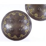 A pair of Antique Islamic shields, with raised bosses, inlaid gold Damascene decoration and