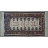 A tribal brown ground rug, 6' x 3' 6"