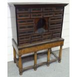 An 18th century collector's cabinet on stand, with 22 panel fronted drawers and arched central