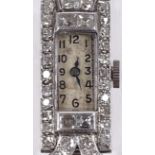 A fine quality platinum and diamond encrusted lady's cocktail wristwatch, set with round, square and