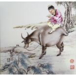 A Chinese porcelain plaque with hand painted scene depicting a figure riding a water buffalo,