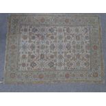 A multi-colour crewel work rug, with floral border, 5' 5" x 3' 11"