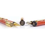 A Parker Duofold Centennial set of pens in orange and black, including fountain pen with 18ct gold