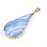 A teardrop-shaped blue lace agate and mother-of-pearl backed pendant, with 9ct gold mounts, height