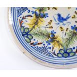 A Continental faience-glazed pottery plate, with painted decoration, diameter 32cm