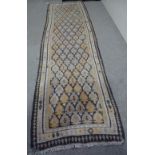 A long cream ground Kelim runner, with symmetrical brown border, 11' 9" x 3' 6"