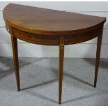 A 19th century mahogany demi-lune fold over tea table, with inlaid stringing, central frieze drawer,