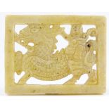 A Chinese relief carved and pierced yellow jadeite dragon design plaque, length 6cm