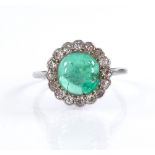 A cabochon emerald and diamond cluster ring, unmarked white metal settings, setting height 14.5mm,