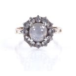 An unusual cabochon star sapphire and white sapphire cluster ring, unmarked gold settings, setting