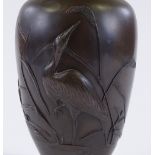 A Japanese patinated bronze narrow-necked vase, circa 1900, relief moulded heron and bulrush design,