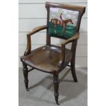 A Victorian oak desk elbow chair, with tapestry upholstered back