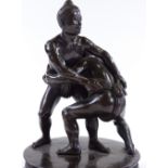 A Japanese bronze Sumo wrestling sculpture, early 20th century, unsigned, on circular ebony stand,
