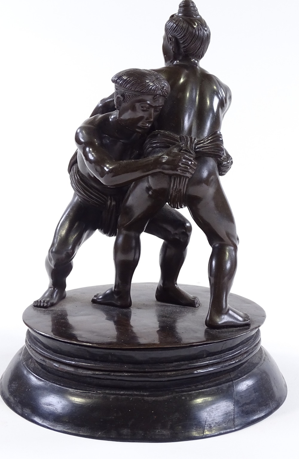 A Japanese bronze Sumo wrestling sculpture, early 20th century, unsigned, on circular ebony stand, - Image 2 of 9