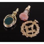 A small banded agate seal fob with gold mounts, a gold mounted swivel fob and a 9ct gold Masonic