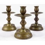 A set of bronze candle stands, height 14cm