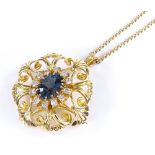 A 9ct gold blue topaz and diamond cluster pendant / brooch, with pierced scroll work body, on 9ct