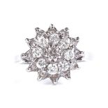 An 18ct white gold diamond cluster ring, total diamond content approx 0.6ct, setting height 12.