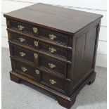 An 18th century joined-oak chest of 4 long graduated drawers, with panelled drawer fronts and