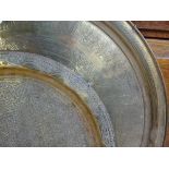 2 engraved Eastern brass trays, 23" largest