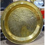 An Eastern brass engraved and embossed table top, 35.5"