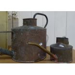 A large Antique copper watering can, length 32", and a small brass watering can