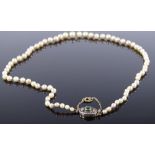A single strand of graduated pearls, with unmarked gold emerald and rose diamond clasp, clasp length
