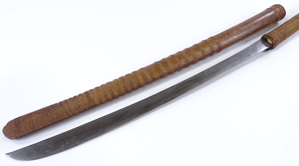 An Antique Japanese sword, with straw-bound handle and original and original straw-bound wood