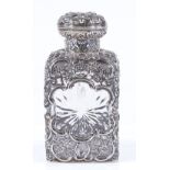 A late Victorian silver-mounted square cut-glass scent bottle, with pierced and relief embossed