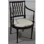 An Edwardian mahogany Hepplewhite style elbow chair, with lattice back