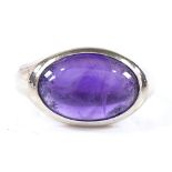 An 18ct white gold cabochon amethyst ring, unmarked but settings test as 18ct, setting height 11.