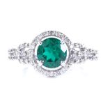 A 14ct white gold synthetic emerald and diamond cluster halo ring, setting height 10.7mm, size N, 3g