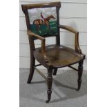 A Victorian oak desk elbow chair, with tapestry upholstered back