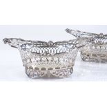 A pair of Edwardian silver bon bon baskets, with pierced surround, and small cast cherub handles, by
