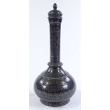 An Oriental silvered metal narrow necked vase and cover, height 34cm