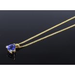 An 18ct gold trillion-cut Tanzanite pendant necklace, on 18ct flat link chain, Tanzanite height 7.