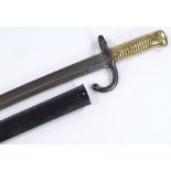 A 19th century French sword bayonet, with brass hilt and original metal scabbard, dated 1872,