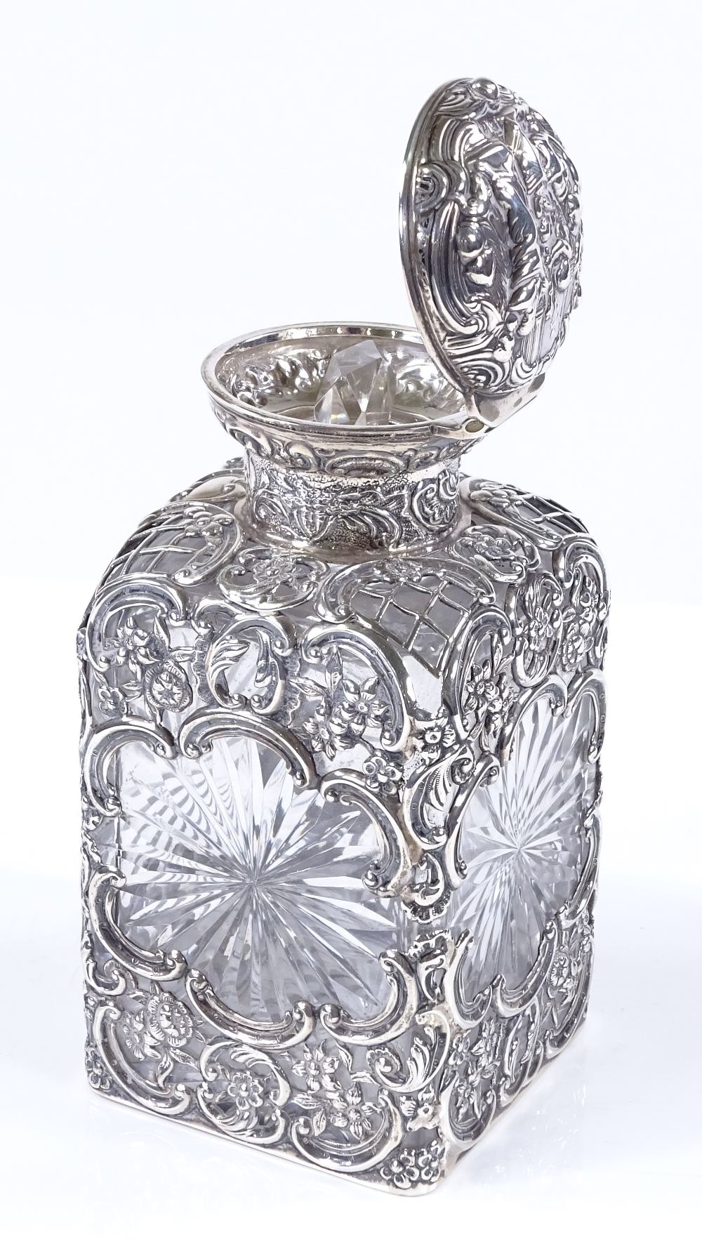 A late Victorian silver-mounted square cut-glass scent bottle, with pierced and relief embossed - Image 2 of 3