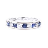 An 18ct white gold sapphire and diamond half eternity ring, total channel set diamond content approx