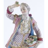 A 19th century Continental porcelain figure of a man holding a basket of flowers, height 27cm