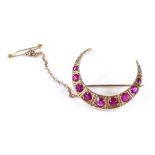 A Victorian ruby and diamond graduated crescent brooch, unmarked gold settings, length 28.8mm, 4.6g